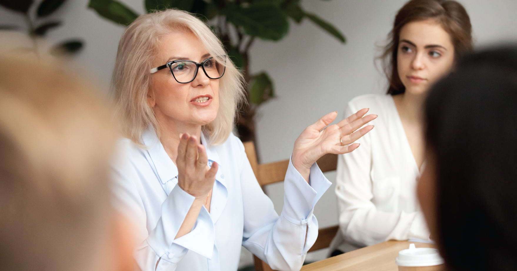 Women Speaking in A Meeting