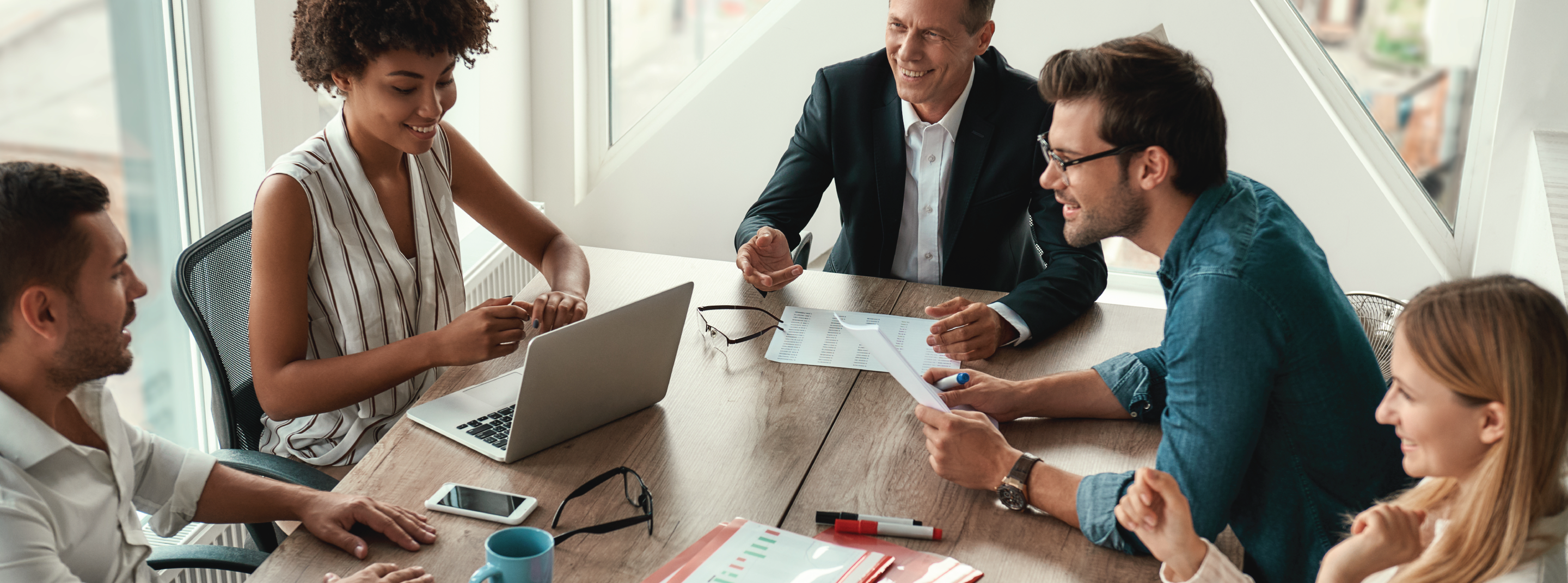 Coworkers in Meeting Around A Table