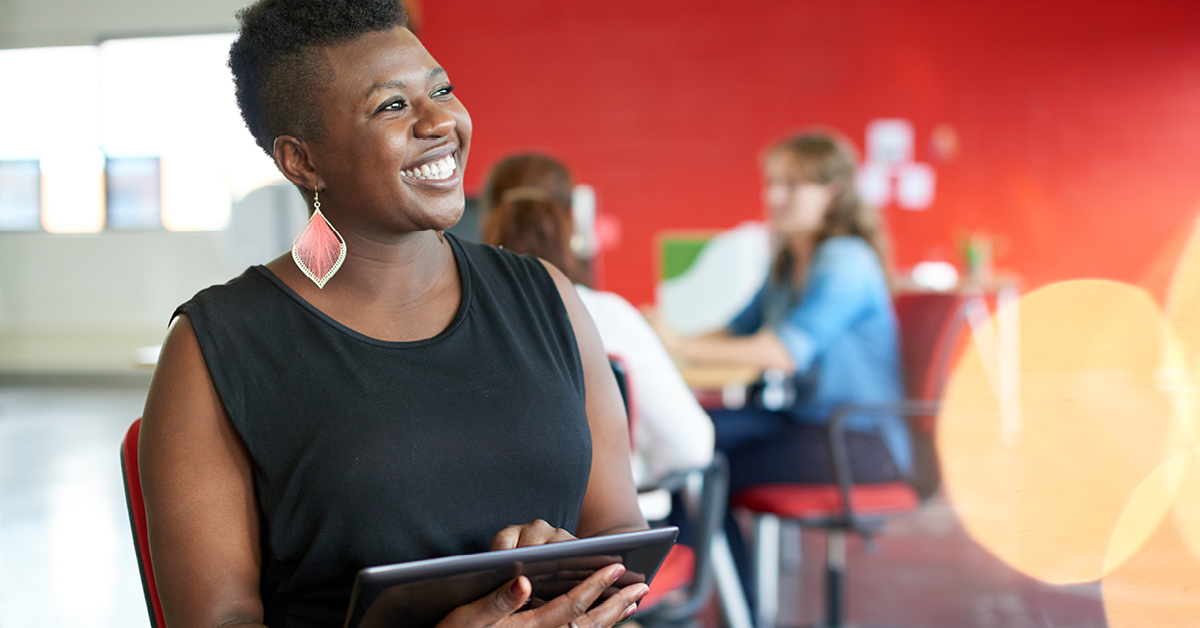 Woman smiling with an ipad