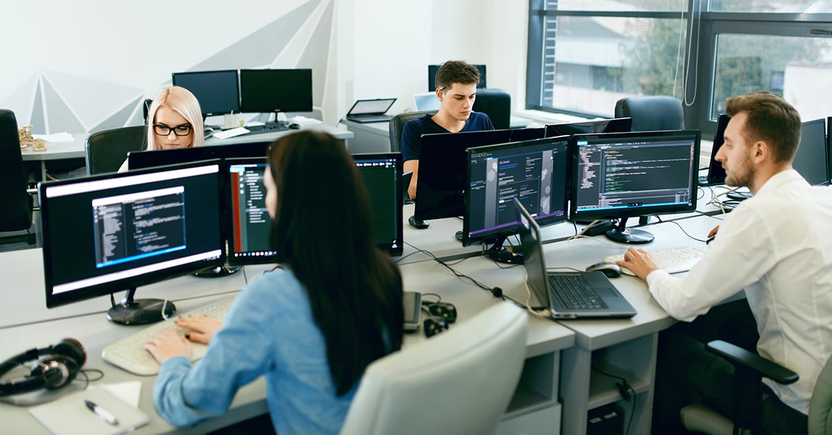 people working on computers at desks