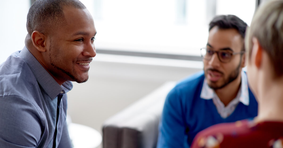 three-colleagues-discussing-business